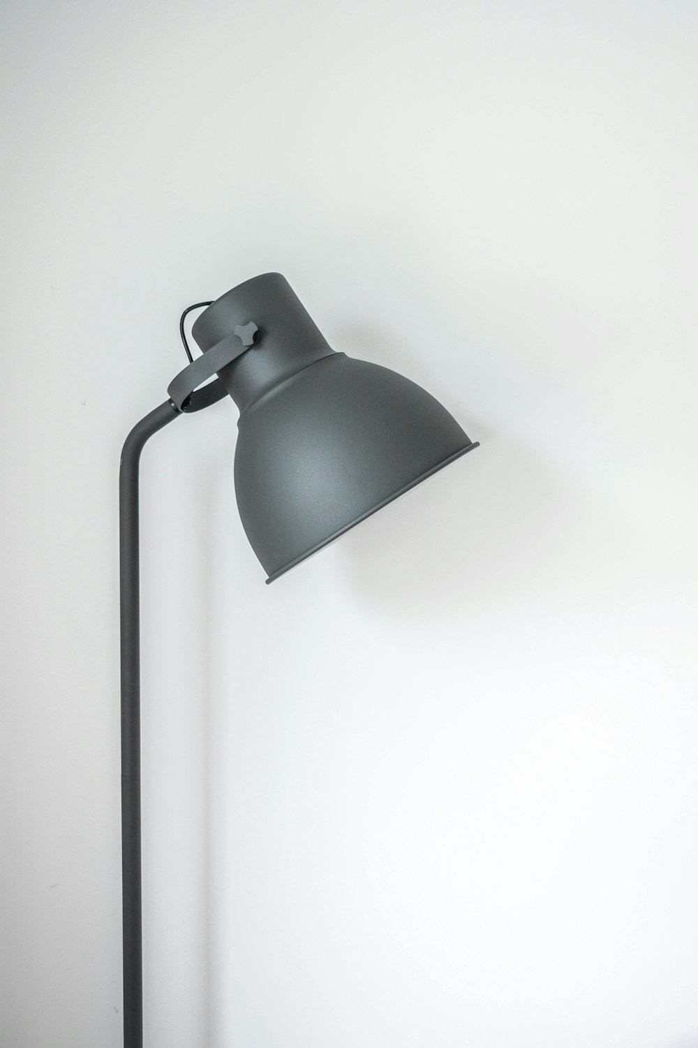 A small lamp on the window sill casting warm light on the ledge and notebook